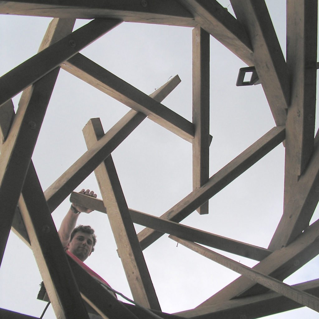 I liked the reciprocal frame roof so much I decided to build another, smaller reciprocal frame (6 beams) on top to support the skylight. As far as I know this makes it the only double reciprocal frame roof in the world!